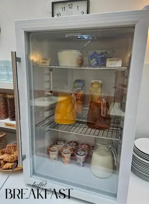 an open refrigerator filled with food and drinks at Hotel Claris in Prague