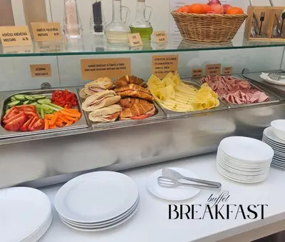 a buffet with plates of food on a counter at Hotel Claris in Prague