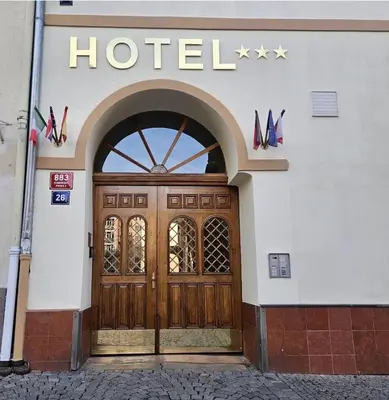 a building with a wooden door with a hotel sign on it at Hotel Claris in Prague