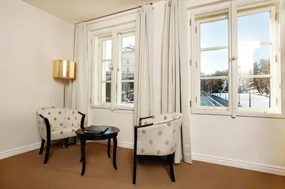 a room with two windows with a view of a city at Hoffmeister Depandance in Prague