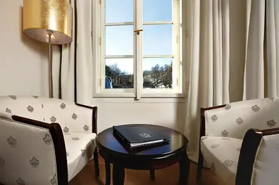 a room with a table and two chairs and a window at Hoffmeister Depandance in Prague