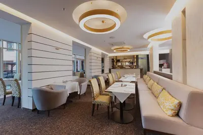 a dining room with chairs and tables in a building at Hoffmeister Depandance in Prague