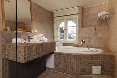 a bathroom with a tub and a sink at Hoffmeister Depandance in Prague