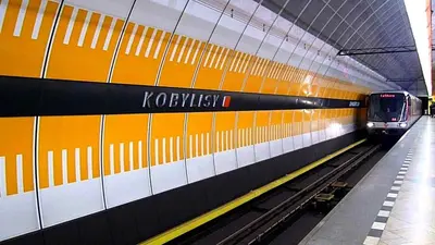 a subway station with two trains on the tracks at Pension Lucie in Prague