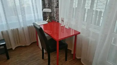 a red desk with a chair and a lamp on it at Pension Lucie in Prague