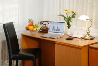 a desk with a laptop computer on top of it at Pension Lucie in Prague