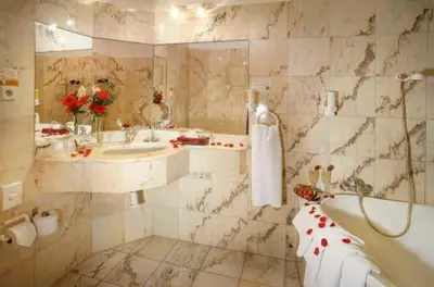 a bathroom with a tub and a sink and a bath tub at Pension Lucie in Prague
