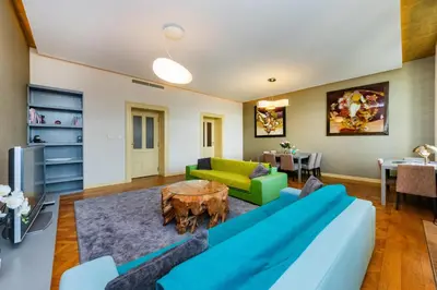 a living room with a couch and a table at Bellevue Apartment in Prague