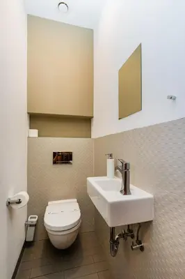 a bathroom with a white toilet and a sink at Bellevue Apartment in Prague