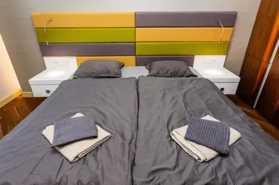 a bedroom with a bed with two towels on it at Bellevue Apartment in Prague
