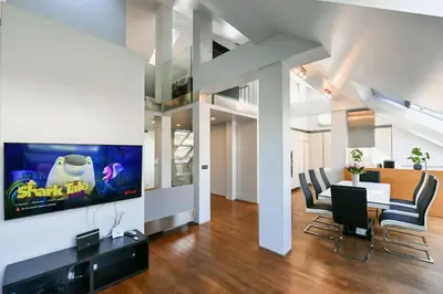 a dining room with a tv and a table and chairs at LUXURY CENTRAL DUPLEX WITH TERRACE in Prague