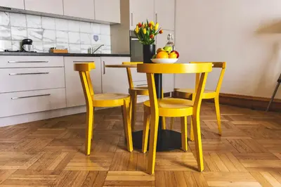 a yellow table and chairs in a kitchen at Art House Apartments by Adrez in Prague