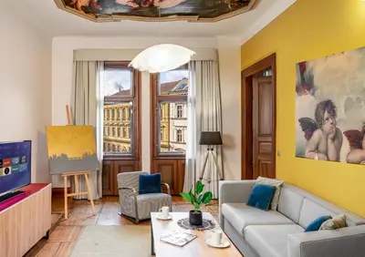 a living room with a couch and a tv at Art House Apartments by Adrez in Prague