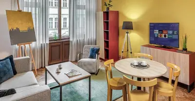 a living room with a couch and a table at Art House Apartments by Adrez in Prague