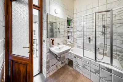 a bathroom with a sink and a tub and a shower at Art House Apartments by Adrez in Prague