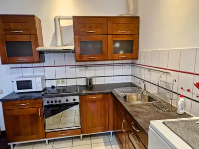 a kitchen with a table and some chairs and a table and a kitchen at Family hotel Maxim in Beroun