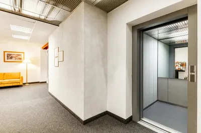 an office lobby with a large wall with a window at Hotel Oáza Praha in Prague