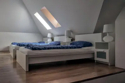 a bedroom with two beds with blue pillows at Onefam Míru in Prague