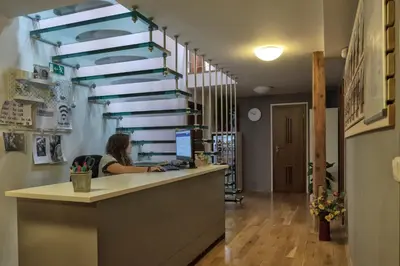 a woman sitting at a counter in a office at Onefam Míru in Prague