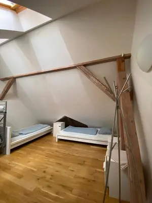 a room with two bunk beds in a attic at Onefam Míru in Prague