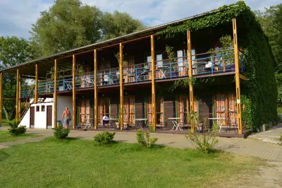 a building with people sitting on the balconies of it at Lávka Park Skochovice in Vrané nad Vltavou
