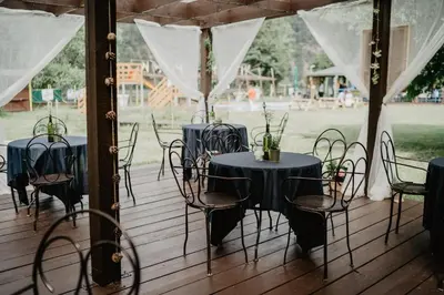 a group of tables and chairs on a deck at Lávka Park Skochovice in Vrané nad Vltavou