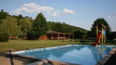 a swimming pool with a slide and a playground at Lávka Park Skochovice in Vrané nad Vltavou