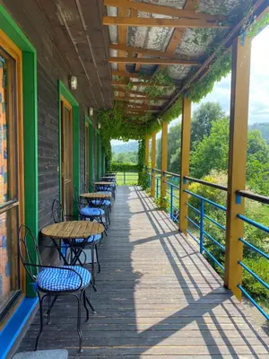 a corridor with tables and chairs on a building at Lávka Park Skochovice in Vrané nad Vltavou