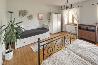 a bedroom with a bed and a potted plant at Zelený statek in Bzová