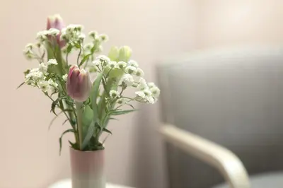 a vase filled with pink and white flowers on a table at Zelený statek in Bzová