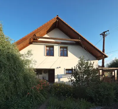 a white house with a brown roof at Zelený statek in Bzová