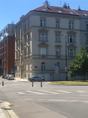 a building with a car parked in front of a street at OLD TOWN SPIRIT in Prague