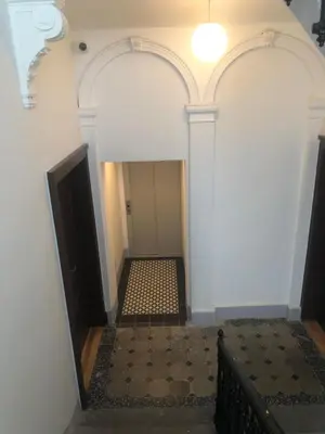 a hallway with white walls and a stairway with a ceiling at OLD TOWN SPIRIT in Prague