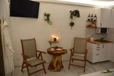 a kitchen with two chairs and a small table and a table with a table at Wellness Vila Bohemia in Prague