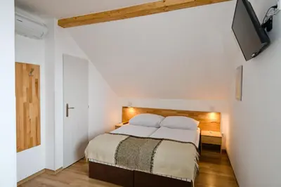 a bedroom with a bed and a flat screen tv at Wellness Vila Bohemia in Prague