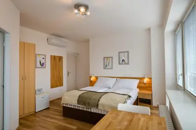 a bedroom with a bed and a table in it at Wellness Vila Bohemia in Prague