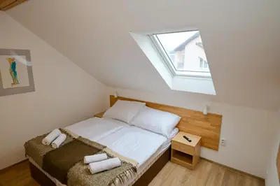 a small bedroom with a bed and a window at Wellness Vila Bohemia in Prague