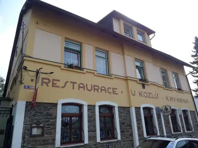 a building with the name of the restaurant on it at Pension Kozel in Ricany