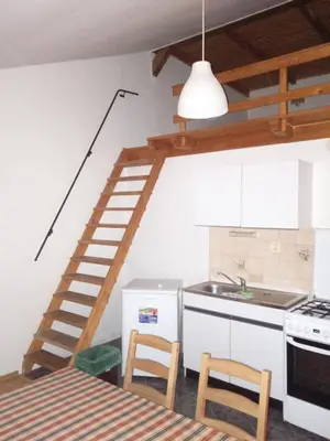 a kitchen with a spiral staircase in the wall at Pension Kozel in Ricany