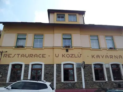 a building with a car parked in front of it at Pension Kozel in Ricany