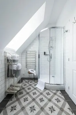 a bathroom with a shower and a tiled floor at Na Kmíně in Obříství