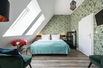 a bedroom with a bed with a green bedspread at Na Kmíně in Obříství