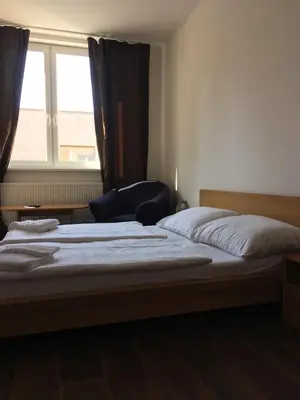 a bedroom with two beds and a window at Hotel Arko in Prague