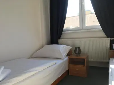 a small bedroom with a bed and a window at Hotel Arko in Prague