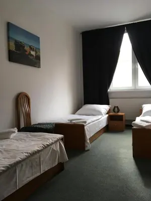 a hotel room with two beds and a window at Hotel Arko in Prague