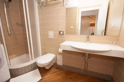a bathroom with a sink and a toilet and a shower at Kozna Loft in Prague