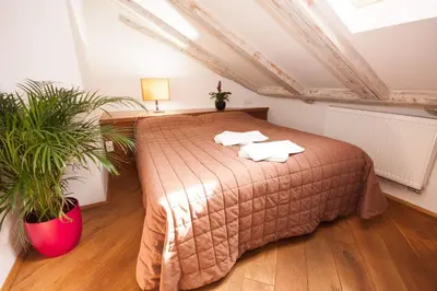 a bedroom with a bed with two towels on it at Kozna Loft in Prague