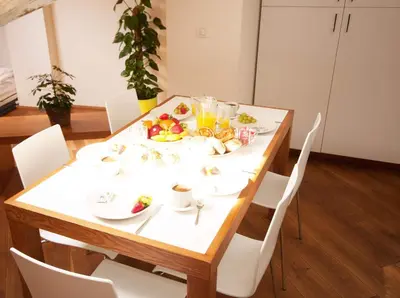 a table with a plate of food on it at Kozna Loft in Prague