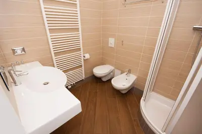a bathroom with a sink and a toilet and a shower at Kozna Loft in Prague