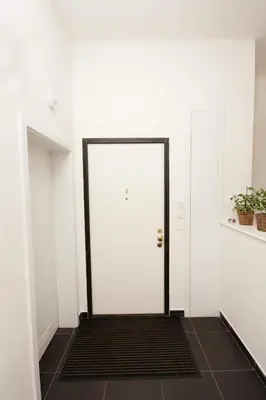 a white door with a black frame in a room at Kozna Loft in Prague